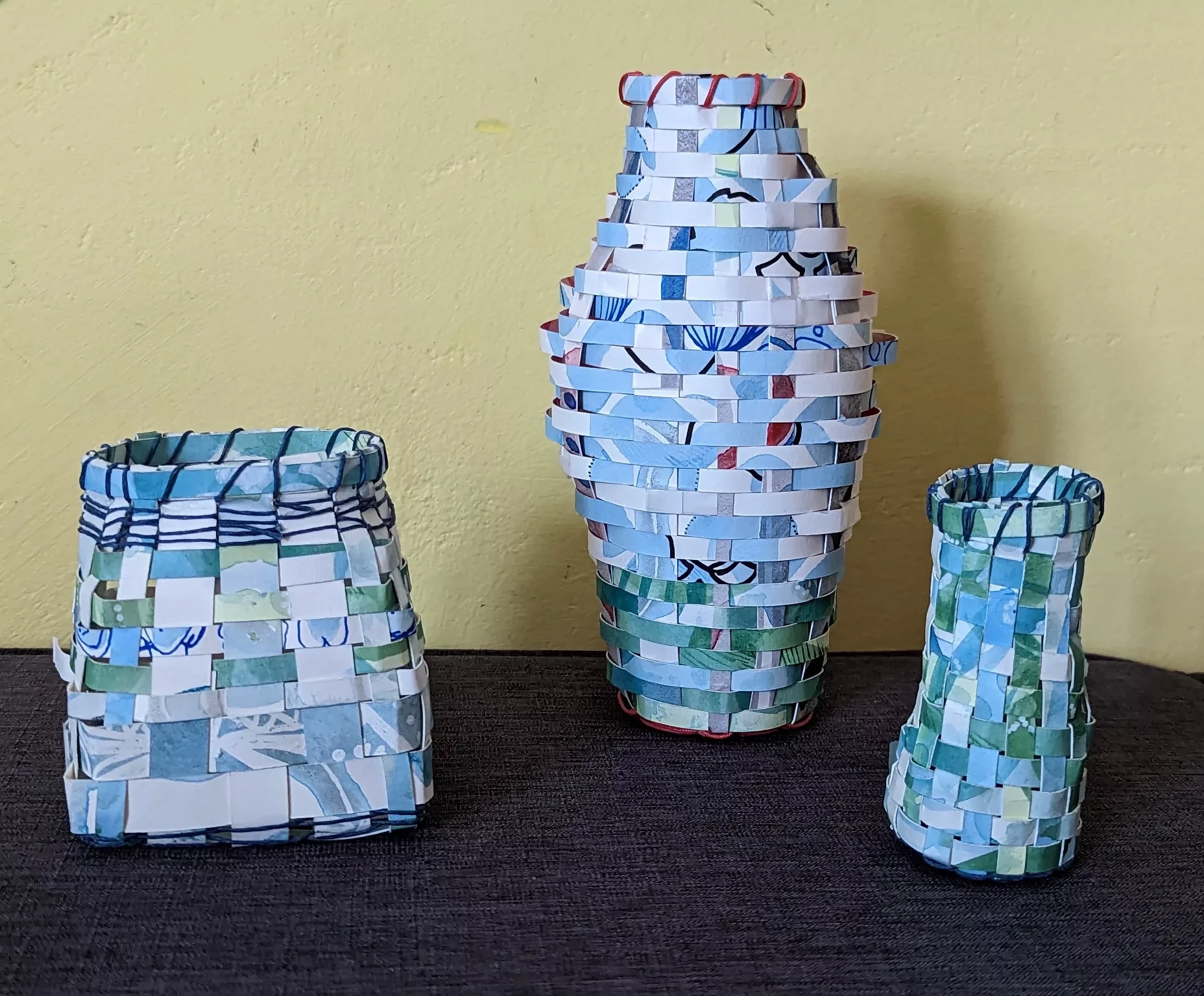 three blue and white woven baskets